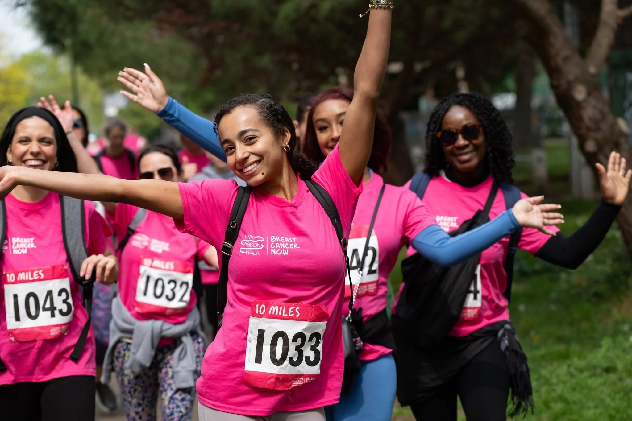 Volunteers in pink race shirts cheering together
